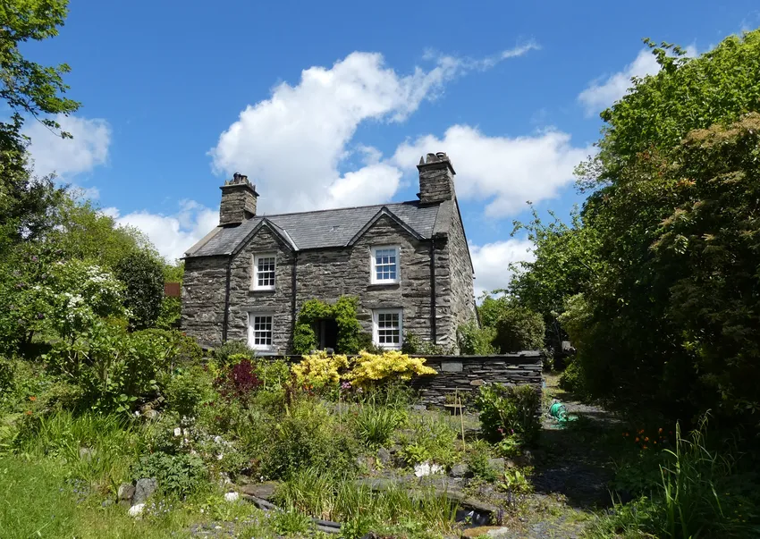 tone house in eryri wales set within mature garden and surrounding landscape