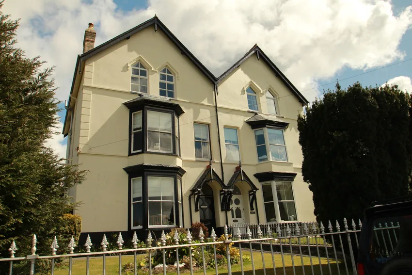traditional house in ceredigion wales with bay windows and painted render finish